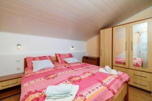 a bedroom with a large bed and a mirror at Apartments Albina in Lopar +111 photos