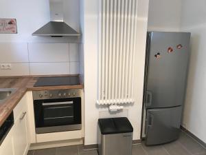 a kitchen with a refrigerator and a stove at Ferienwohnung Udenheim in Udenheim