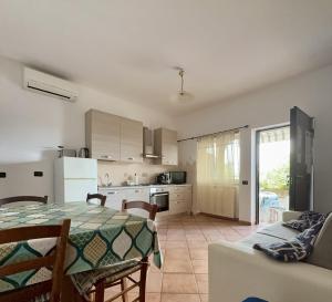a kitchen and living room with a table and a couch at La casa tra gli ulivi di Fonte Nuova in Fonte Nuova +24 photos
