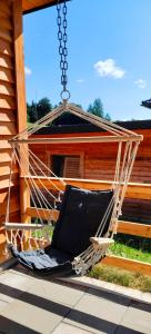 a hammock hanging from a porch of a house at DingDong in Unteraichwald