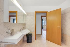 a bathroom with a sink and a mirror at Gambarogno Vista Bella 1 - Happy Rentals in Piazzogna +22 photos