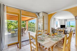 a dining room with a table and a room with a balcony at Gambarogno Vista Bella 1 - Happy Rentals in Piazzogna