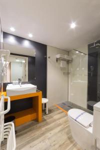 a bathroom with a sink and a toilet and a shower at Sandos Benidorm Suites in Benidorm