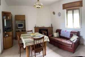 a living room with a table and a couch at Wanderlust per chi ama la natura in Laino Castello