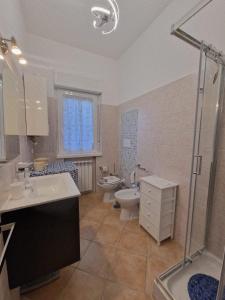 a bathroom with a toilet and a sink and a shower at La Casa di Taty in Campagnano di Roma