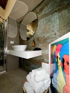 a bathroom with a sink and a mirror at Ginevra Boutique Rooms - Palazzo Leosini - Residenze D'Epoca in LʼAquila