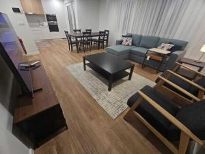 a living room with a couch and a table at Apartamento Sonho Terra in Ponta Delgada