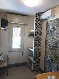a room with a wall with a window and shelves at Hotel CARLO in Riccione