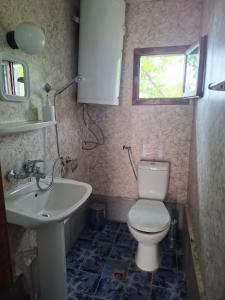 a bathroom with a white toilet and a sink at Bunaglows Panoramic Beach Village in Balchik +16 photos