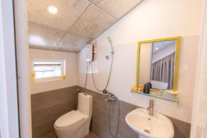 a small bathroom with a toilet and a sink at Blue Windy Đà Lạt Homestay in Da Lat