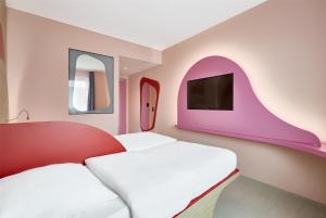 a room with two beds and a tv at Prize by Radisson, Munich Airport in Hallbergmoos