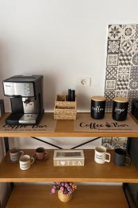 a wooden shelf with a printer and cups on it at Casa Maxim Eforie Nord in Eforie Nord +35 photos