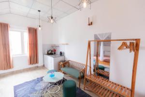 a living room with a bed and a table at Blue Windy Đà Lạt Homestay in Da Lat