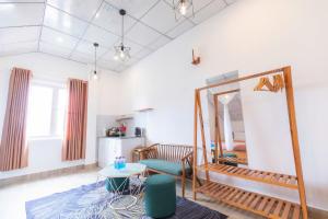 a living room with a mirror and a table at Blue Windy Đà Lạt Homestay in Da Lat +51 photos