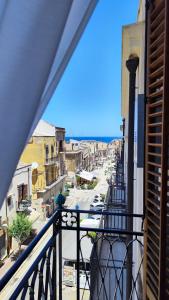 a view of a city from a balcony at Disìu Apartment con Jacuzzi in centro a Castellammare del Golfo in Scopello