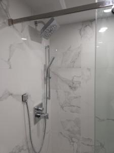 a bathroom with a shower with a glass door at vistaeast 1-Bedroom Condo Rupert st in Vancouver