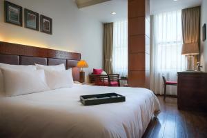 Voodi või voodid majutusasutuse Hanoi E Central Luxury Hotel & Restaurant toas