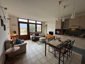 a kitchen and living room with a table and chairs at Casa Lucrezia by Gottschalk in Colico