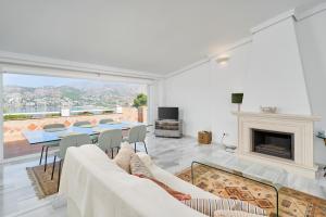 a living room with a table and a fireplace at Casa Bahía Azul in La Herradura