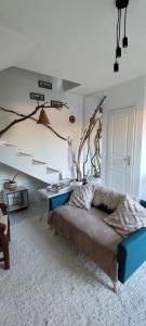 a bedroom with a bed with a tree branch on the wall at Casa Di l'alba in Borgo
