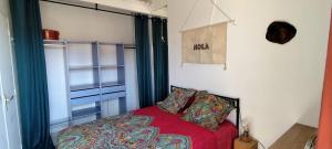 a bedroom with a red bed and a window at Casa Di l'alba in Borgo