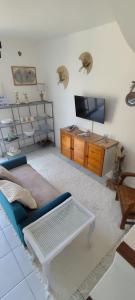 a living room with a couch and a tv at Casa Di l'alba in Borgo +13 photos