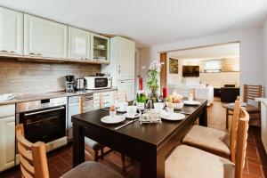 a kitchen and dining room with a table and chairs at Teufels - Zuflucht in Thale