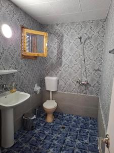 a bathroom with a toilet and a sink and a shower at Bunaglows Panoramic Beach Village in Balchik