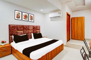 a bedroom with a large bed in a room at Collection O Kargil Complex Saarthi Inn in Agra