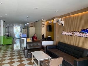 a woman sitting at a counter in a fast food restaurant at Smart Place Pattaya in Pattaya
