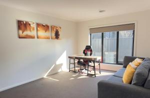 a living room with a couch and a table at Brooklyn Haven in Thurgoona