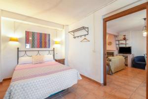 a bedroom with a bed and a living room at Casa Rural La Trastienda in Almonaster la Real +22 photos