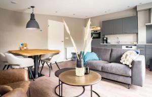 a living room with a couch and a table at C-65 Stoeterij in De Cocksdorp