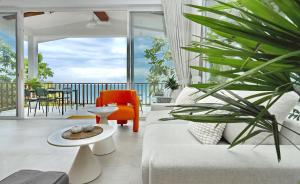 a living room with a white couch and a plant at Haad Yao Villa 13 Luxury Sea View & Pool in Koh Phangan