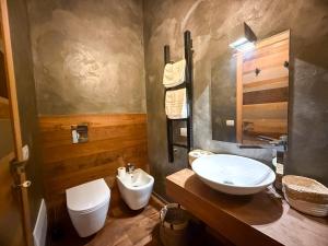 a bathroom with a sink and a toilet at Tenuta Rurale Luxury&Nature in Gravina in Puglia
