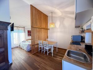 a kitchen and dining room with a table and a bed at Tenuta Rurale Luxury&Nature in Gravina in Puglia +31 photos