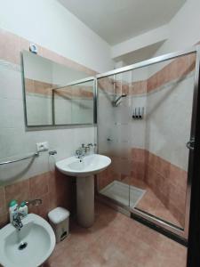a bathroom with a sink and a shower at Mirama in Valledoria