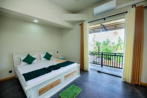 Un dormitorio con una cama y una ventana grande. en Crystal Resort, en Galle