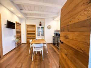 a dining room with a wooden table and chairs at Tenuta Rurale Luxury&Nature in Gravina in Puglia