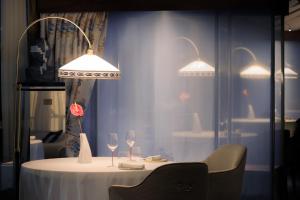 a table with two lamps and two wine glasses at Grand Hotel Principe Di Piemonte in Viareggio
