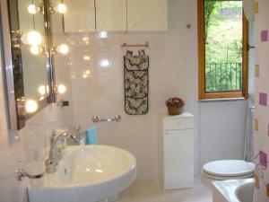 a white bathroom with a sink and a toilet at Freetime in Perugia