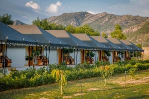 un edificio con tetto con montagne sullo sfondo di Orchards verdant Resort Pushkar a Pushkar