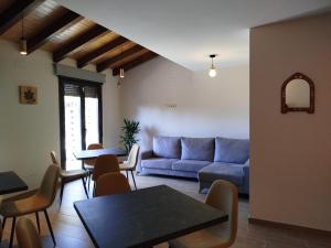a living room with a couch and a table and chairs at Hotel Rural El Pingón in Manzanal de Arriba
