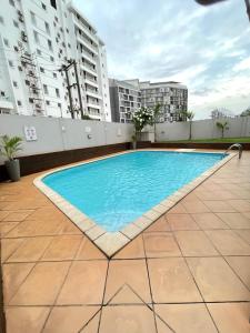 a swimming pool on the roof of a building at Sunny's Place Luxury Apartments in Accra