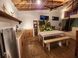 a kitchen with a table and a bench in it at Marajaw Annex in General Luna