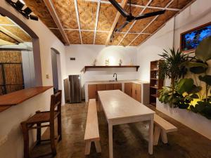 a kitchen with a table and a sink at Marajaw Annex in General Luna