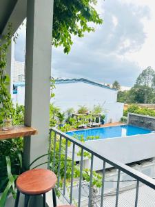 a balcony with a view of a swimming pool at 407MSNK Maison Luxe Studio w Balcony & Kitchen in Can Tho