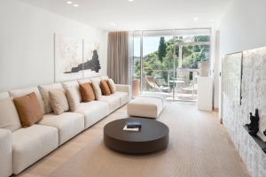 a living room with a white couch and a coffee table at Villa Dubrovnik in Dubrovnik
