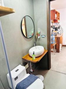 a bathroom with a sink and a mirror at 407MSNK Maison Luxe Studio w Balcony & Kitchen in Can Tho +16 photos