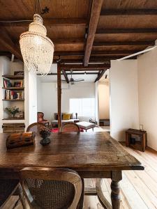 a dining room with a wooden table and chairs at Locanda Laltra Cucina in Yokosuka +39 photos